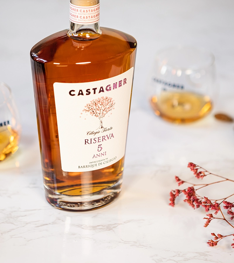Flasche Castagner Grappa Barrique di Ciliegio Riserva 5 Anni, im Kirschholz-Barrique gereift, mit zwei Grappagläsern